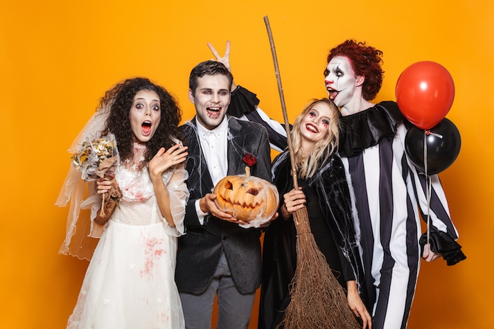 Halloween Costumes The image displays an image of four students excited for Halloween and dressing up.