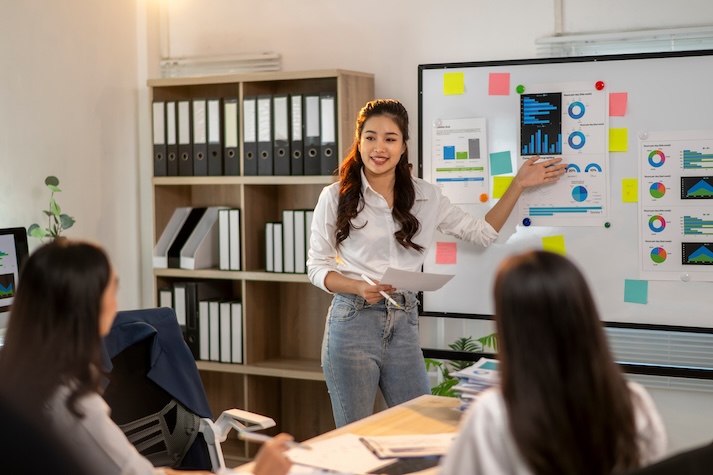 A team of advertisers studying data. The image displays a team of people studying data numbers.
