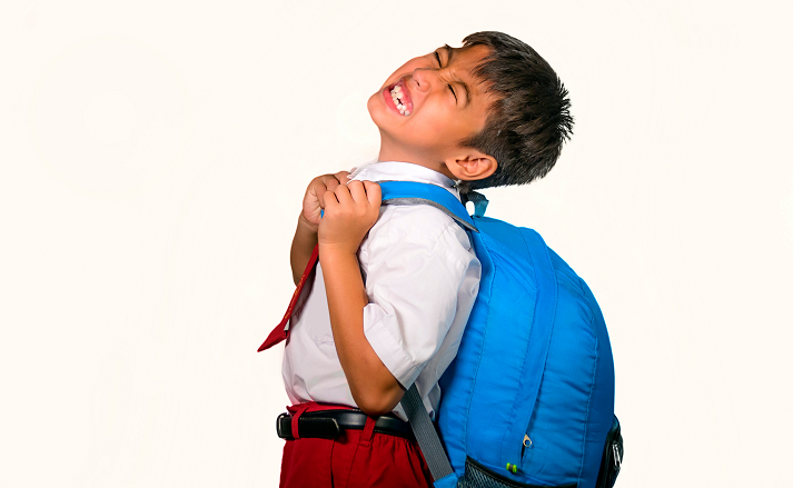 kid carrying a heavy backpack