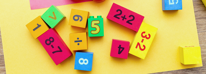 child kid colorful education toys cubes with numbers math pattern background on the bright background.