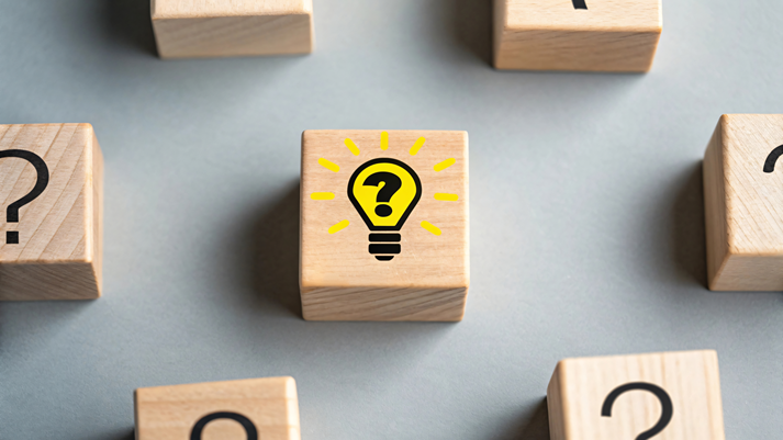 Wooden blocks with question marks and lightbulb idea