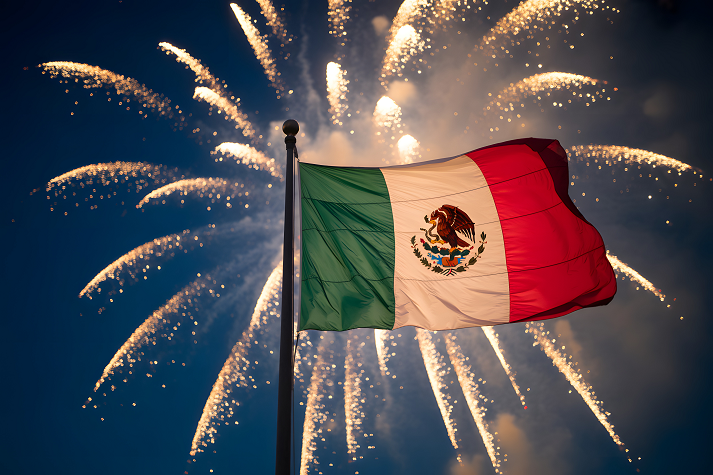 Vibrant Mexican flag waving proudly under stunning fireworks display, celebrating national pride and festive spirit on Independence Day