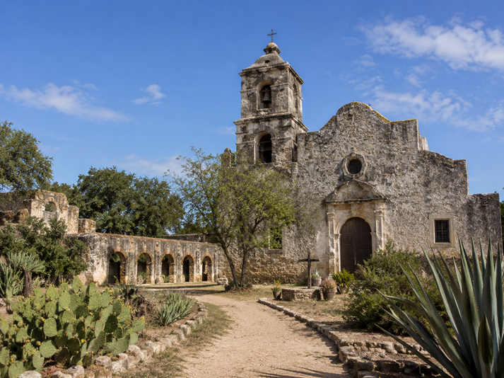 Historic mission with desert landscaping