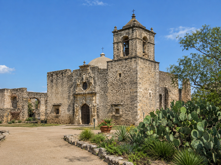 Historic mission facade with desert garden