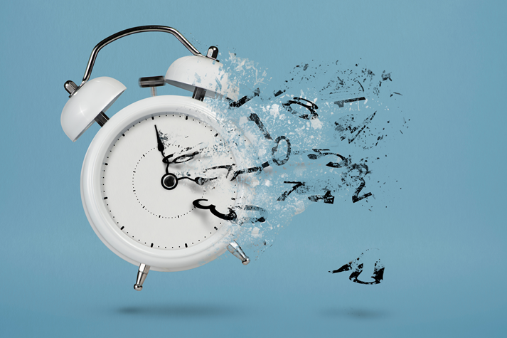 White alarm clock with flying numbers as a symbol of lost time