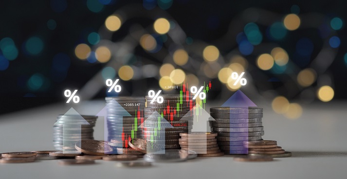 heap of coins with an upward arrow and stock market chart symbolizes rising interest rates, investment growth, mortgage returns, and financial gains from business performance