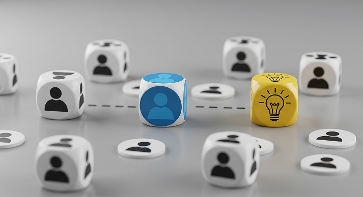 making informed decisions Dice with people icons and lightbulb representing connection and ideas on a gray surface concept