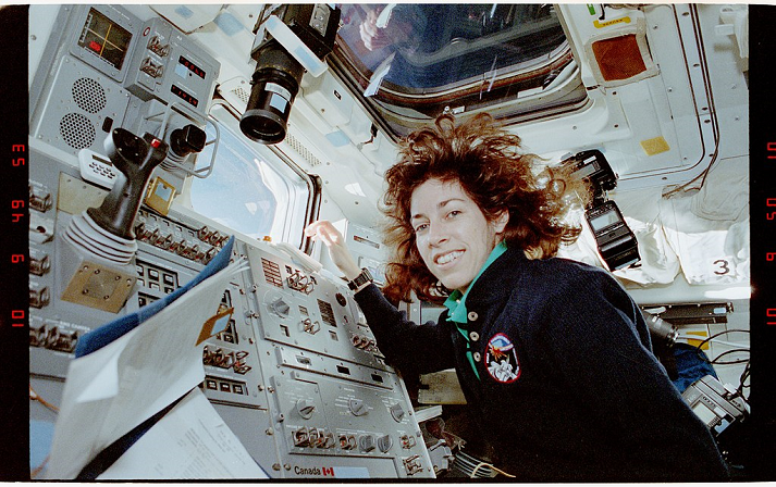 Candid views of Mission Specialist Ellen Ochoa in the aft flight deck by the RMS closed circuit television monitor screens