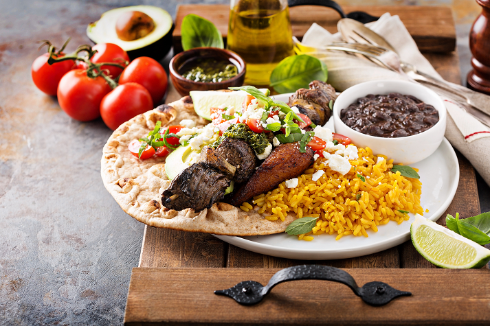 Beef kebab with rice, beans and fried plantains