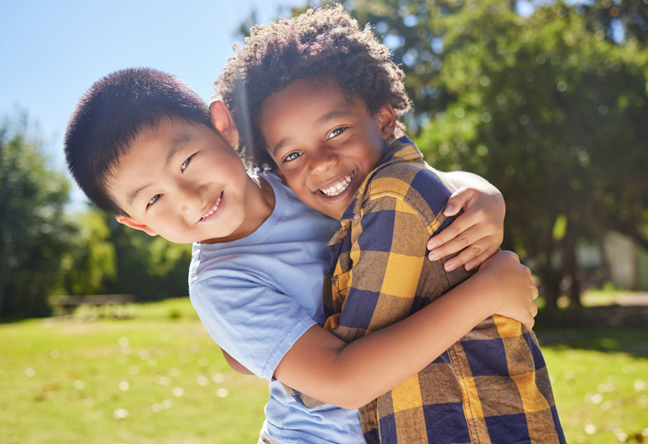 Portrait, children and friends hugging in a park together for fun, bonding or playing in summer