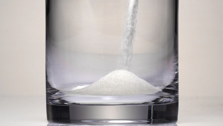 pouring salt into a glass