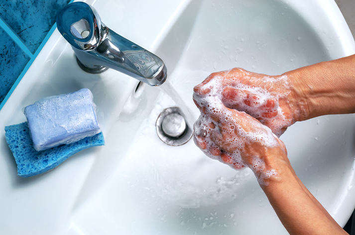 soapy hand over the washbasin