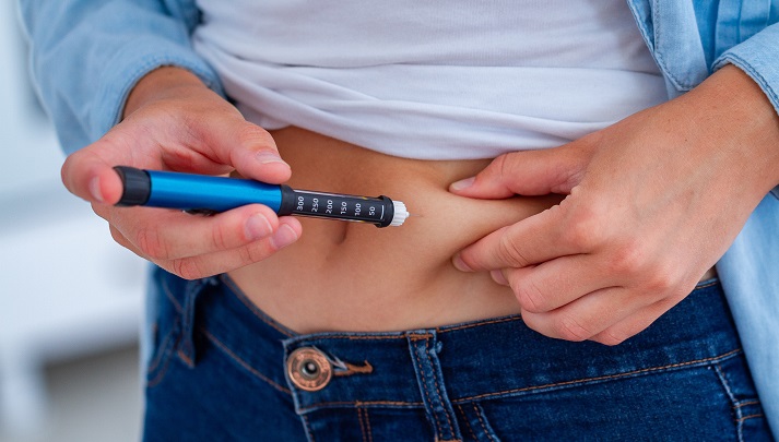 insulin injection A diabetic patient makes an insulin injection with insulin pen at home. Treatment sugar diabetes