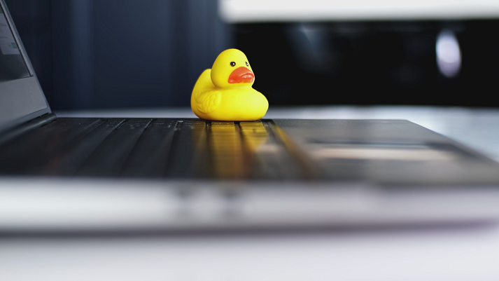 Yellow Rubber Duck Sitting on Laptop