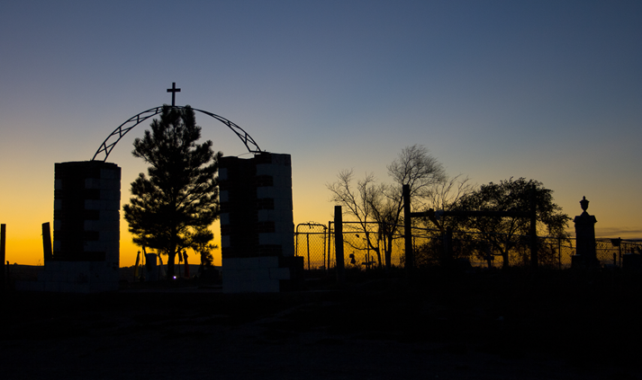 Silhouette of the entrance to the Wounded Knee Massacre Monument in South Dakota at sunrise