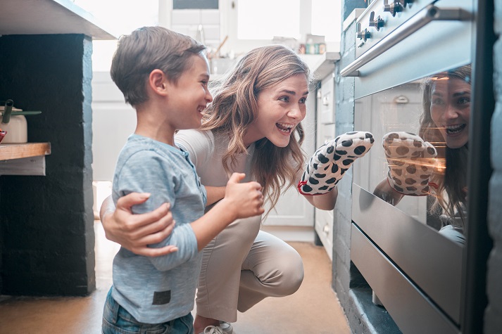 cooking mom and son using the oven