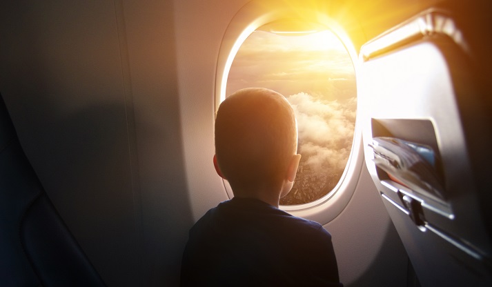 boy in a plane looking out the window boy in a plane looking out the window