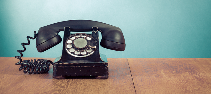 Retro telephone on table in front mint green background