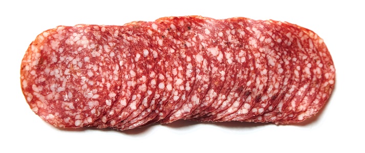 Thin sliced salami sausage isolated on white