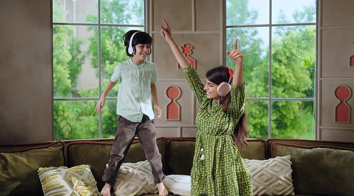 brother and sister singing and dancing to music in the living room