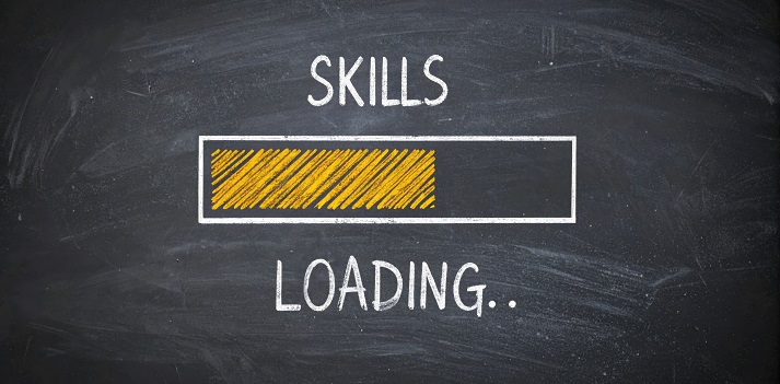 Progress bar sketched on a chalkboard with the words 'skills loading' symbolizing ongoing personal development, career growth, and continuous learning