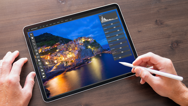 Person using photo editor on digital tablet