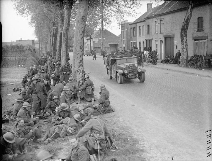 troops resting in France A truck passes a group of Belgian troops resting by the roadside in Louvain, 14 May 1940.