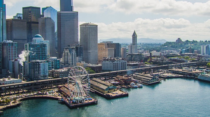 Seattle, Washington waterfront aerial drone view with the viaduct Alaskan Highway. Great Wheel to Smith Tower